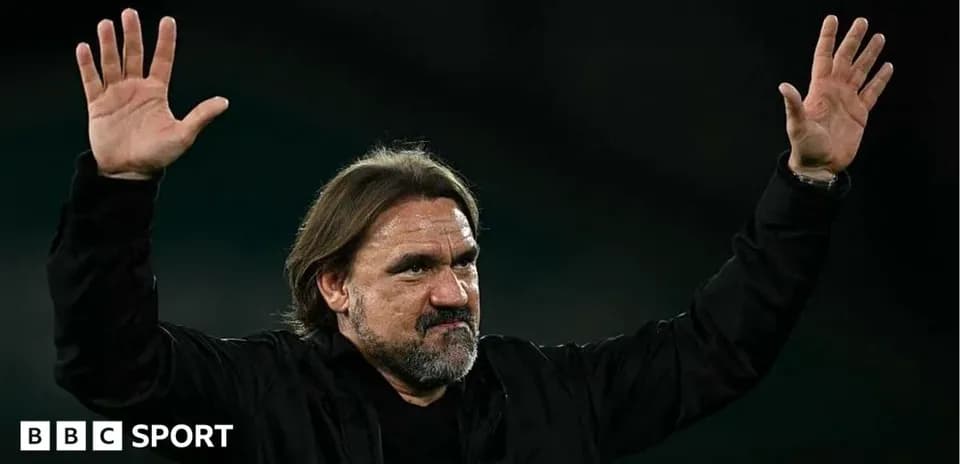 Coach waving to fans after match conclusion