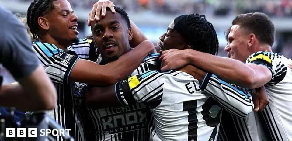 Players celebrating a goal in team jerseys