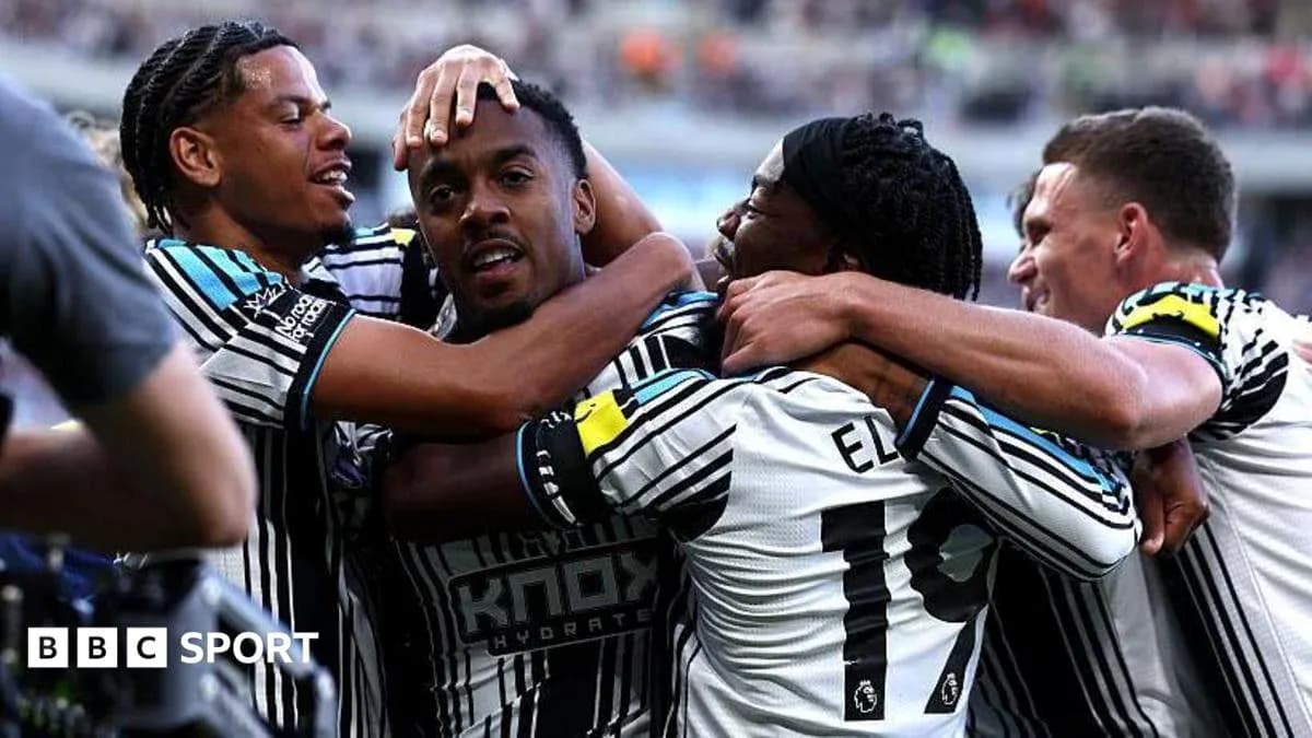 Players celebrating a goal in team jerseys