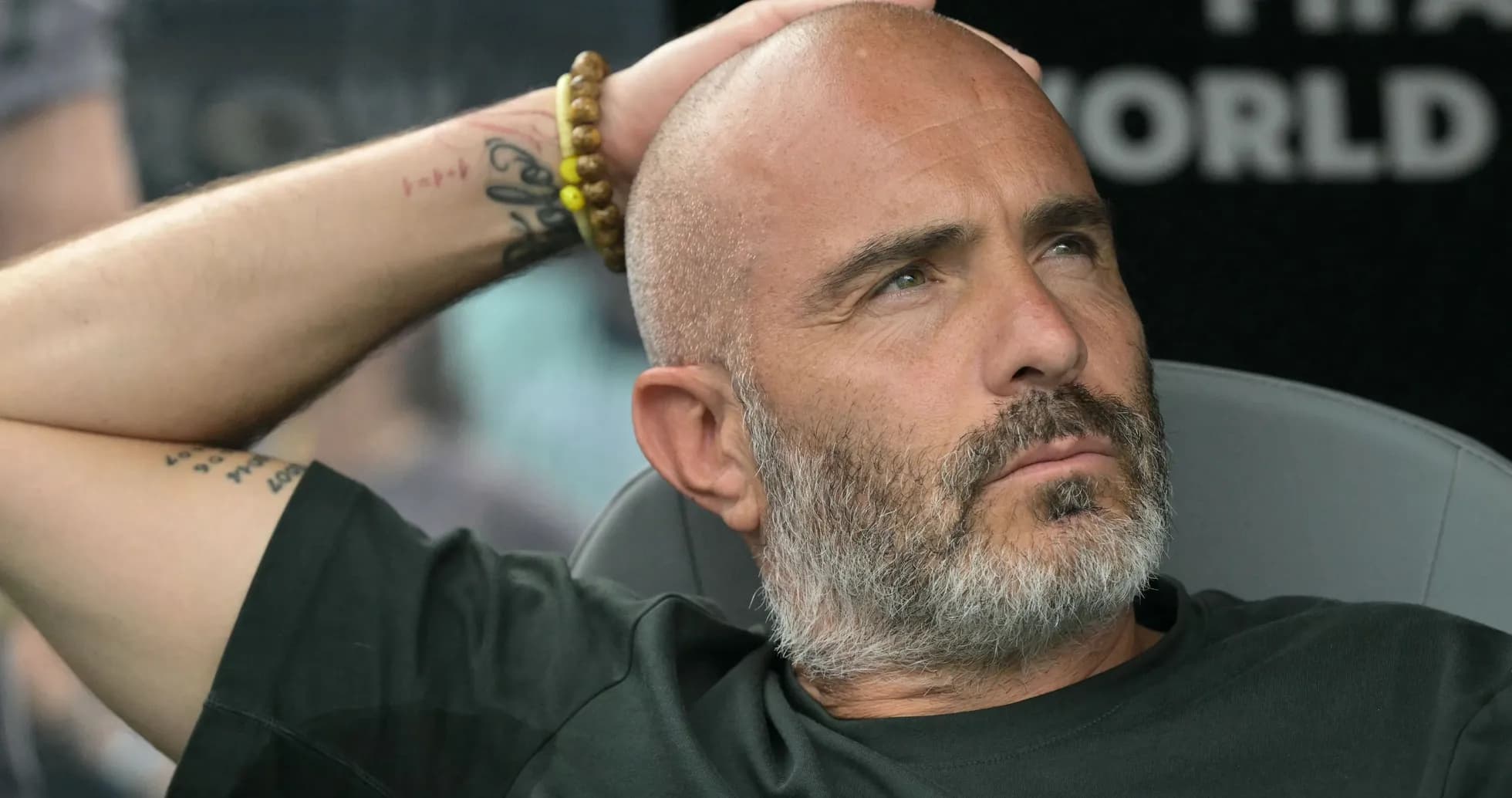 Coach sitting on bench during a match