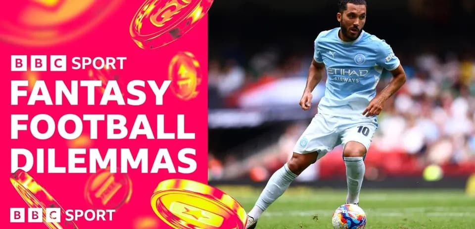 Player in light blue kit dribbling football on pitch