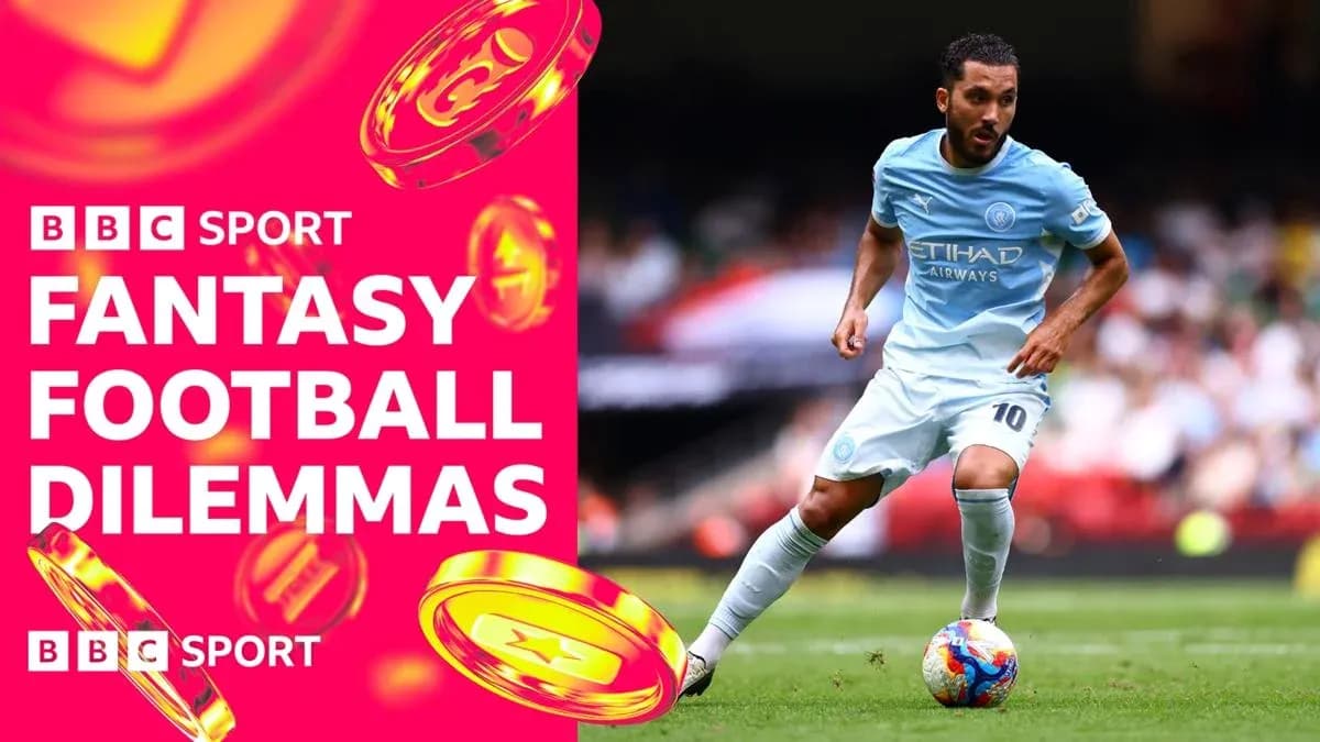 Player in light blue kit dribbling football on pitch