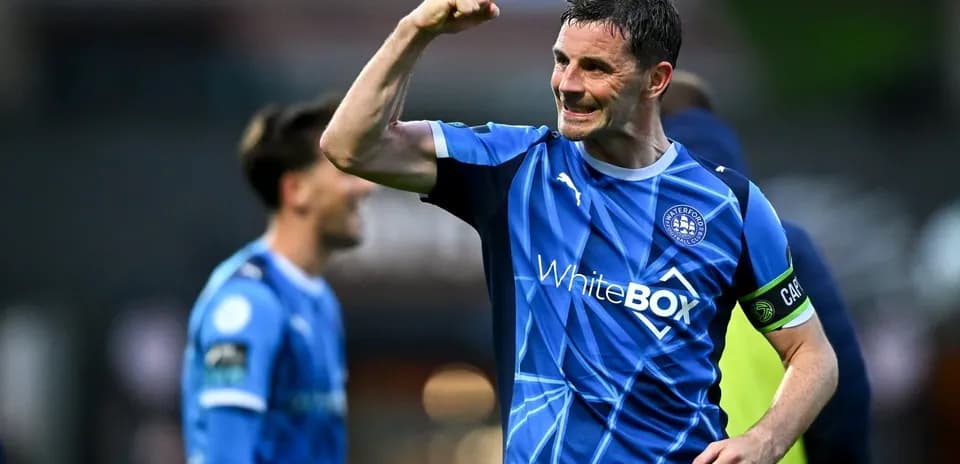 Player celebrating with raised fist in blue jersey
