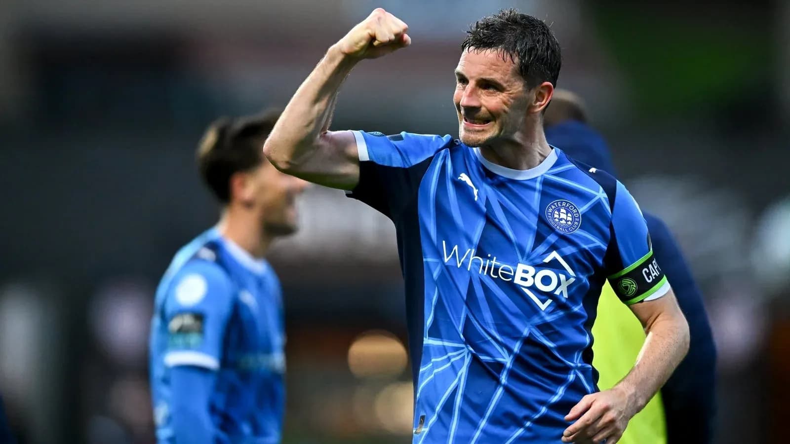 Player celebrating with raised fist in blue jersey
