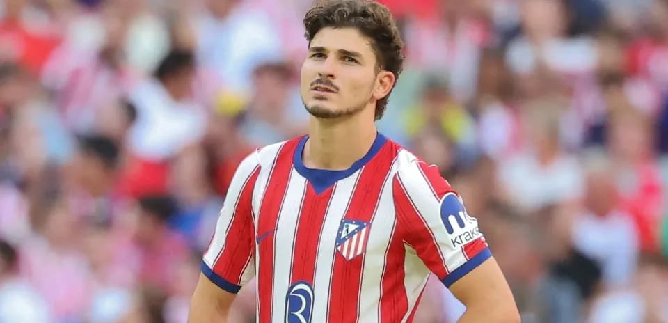 Atletico Madrid player looking thoughtful on field