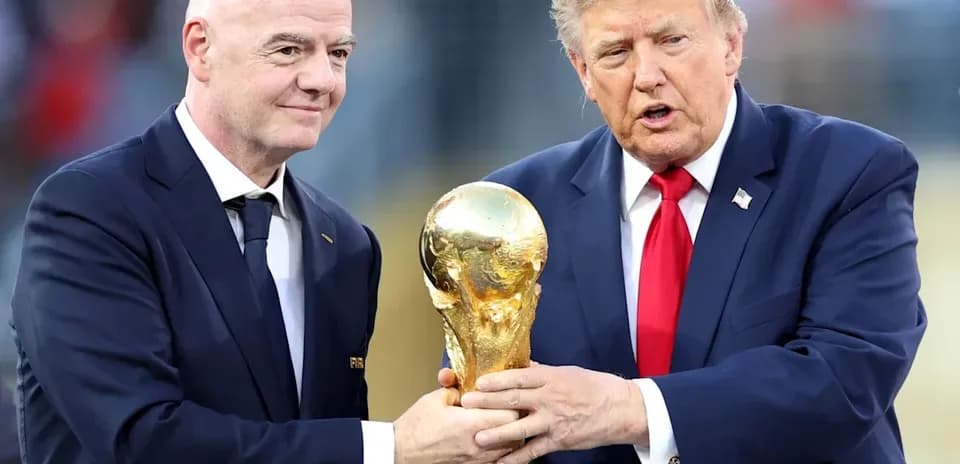 Two men holding the FIFA World Cup trophy