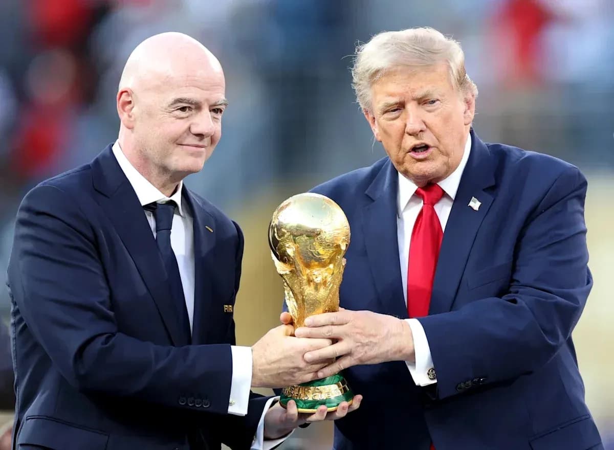 Two men holding the FIFA World Cup trophy