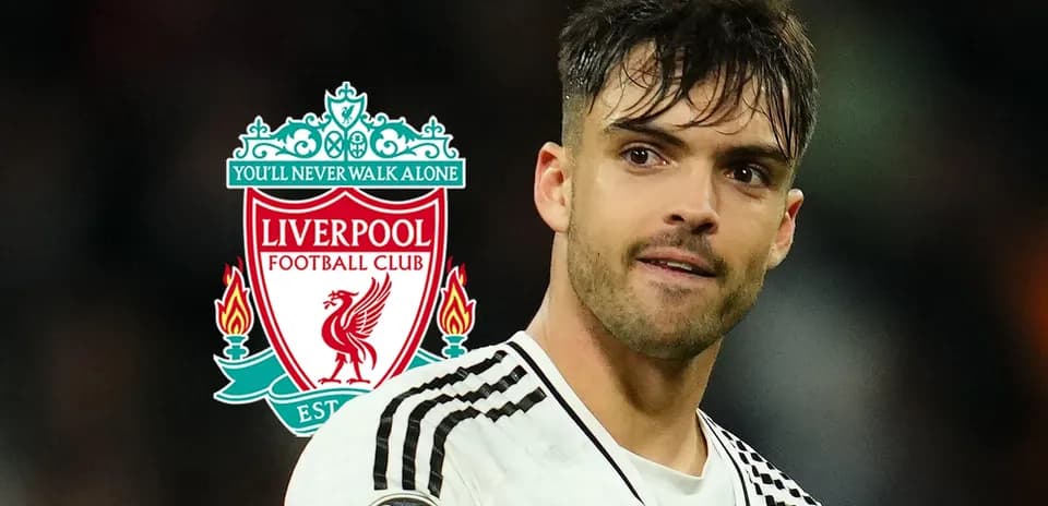 Player in foreground with Liverpool FC logo background