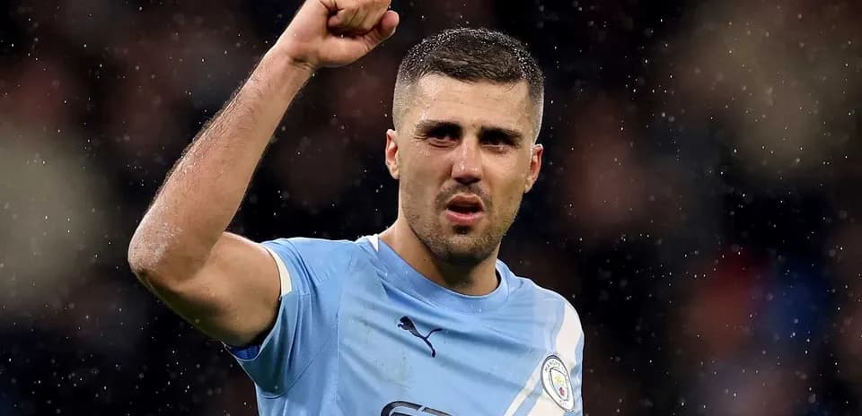 Player celebrating with raised fist in Manchester City kit