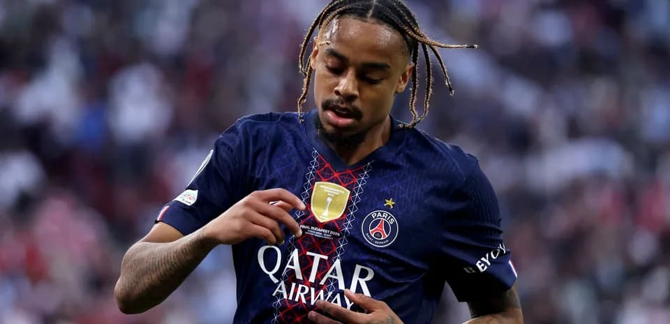 Player adjusting jersey with PSG badge during match