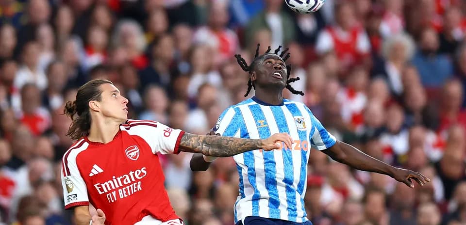 Arsenal player challenges Coventry player for ball