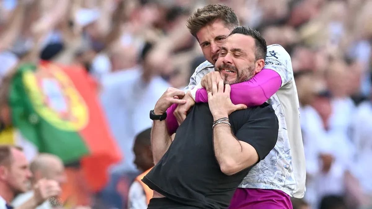 Two coaches celebrating an exciting moment together