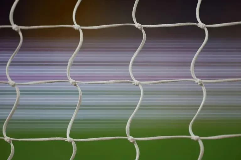 Close-up of soccer net with blurred background