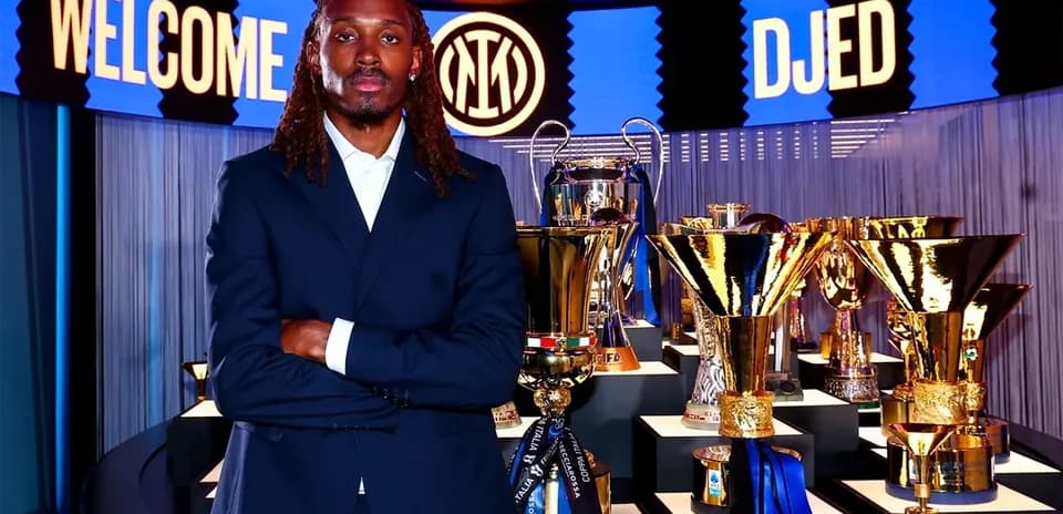 Player standing in front of trophies at unveiling