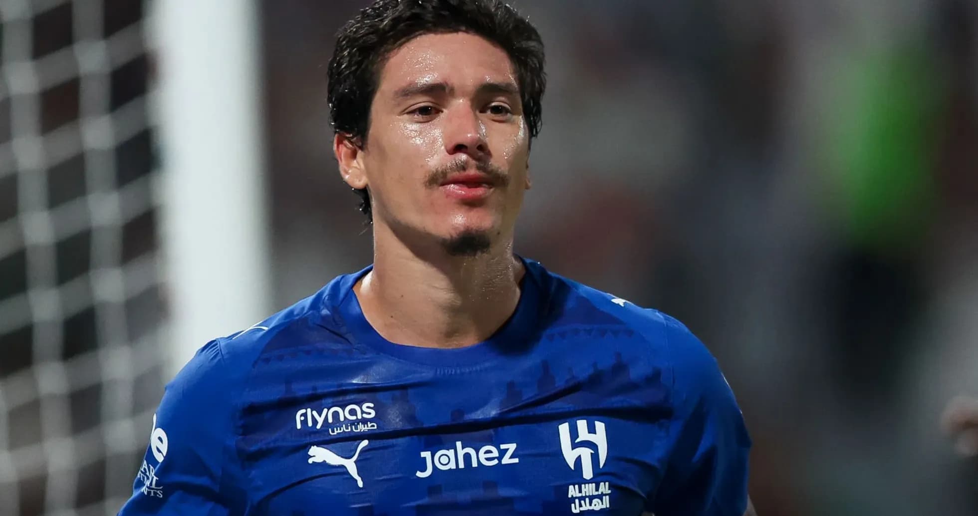 Player wearing blue jersey celebrating after match