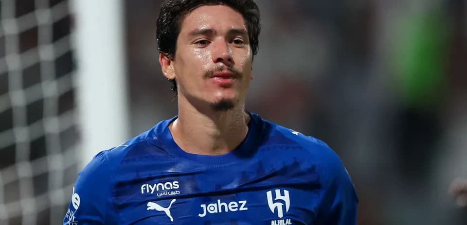 Player wearing blue jersey celebrating after match