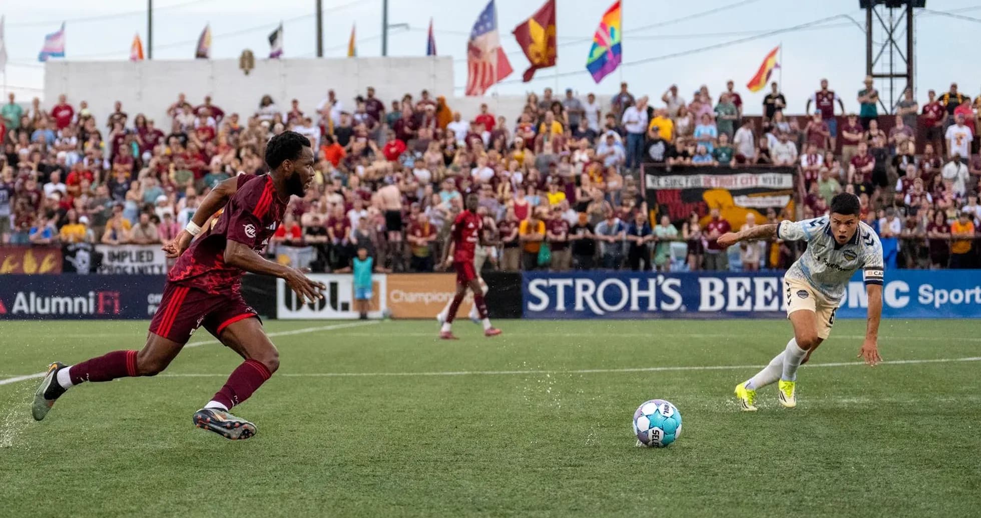 Players competing for the ball during Detroit City match