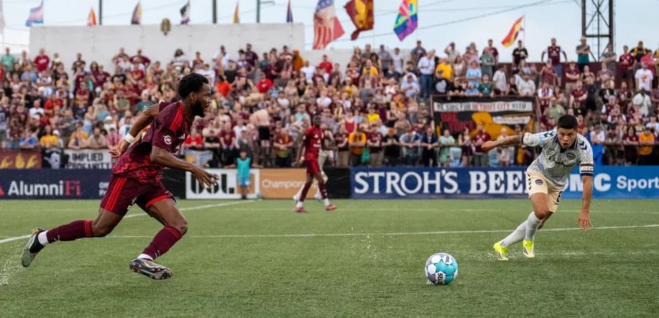 Players competing for the ball during Detroit City match