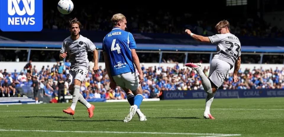 Player kicking ball during soccer match action