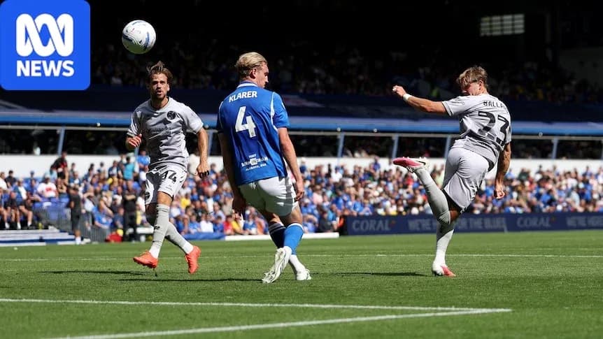 Player kicking ball during soccer match action