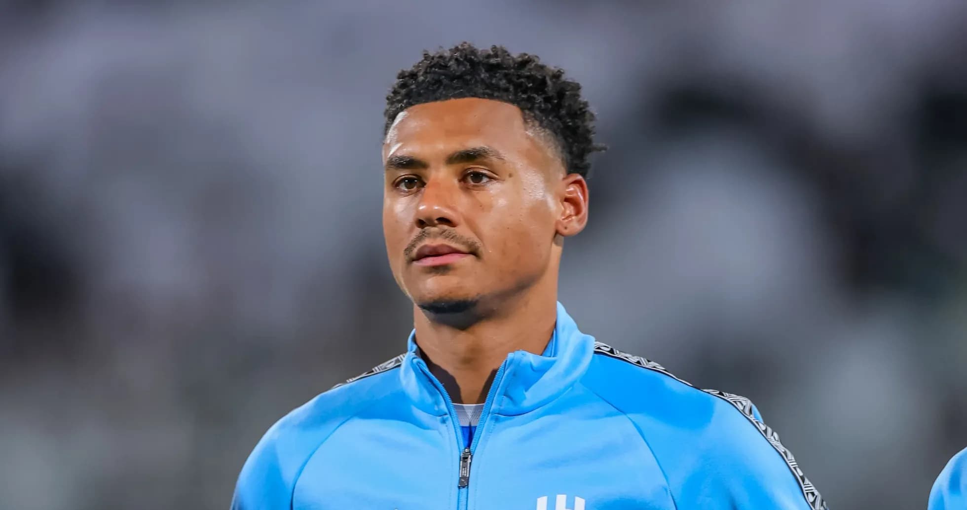 Player in blue warm-up jacket on the field