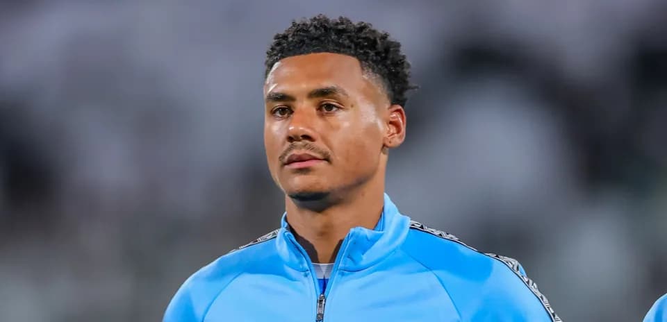 Player in blue warm-up jacket on the field