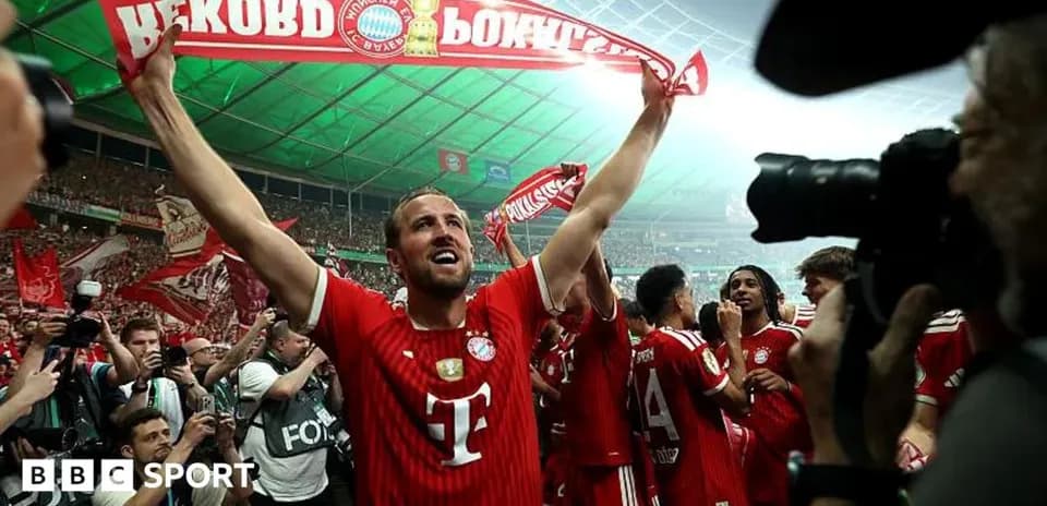 Player celebrating with fans and holding a banner