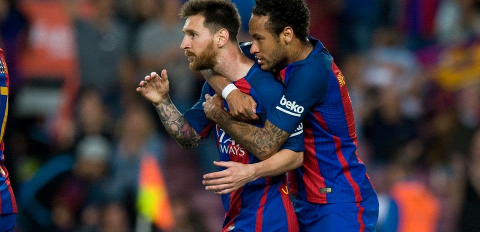 Lionel Messi celebrating with Neymar after scoring