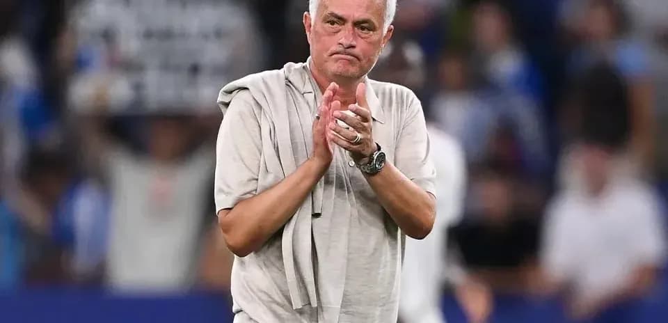 Coach clapping towards fans after match