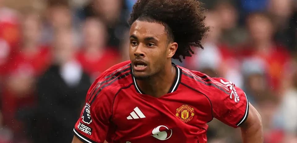 Player in red Manchester United kit running on pitch