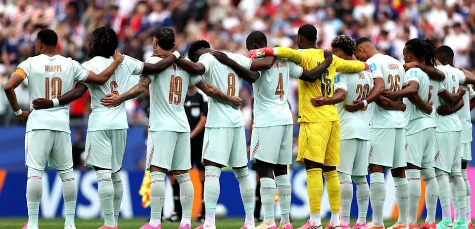 Players from France standing in solidarity before match