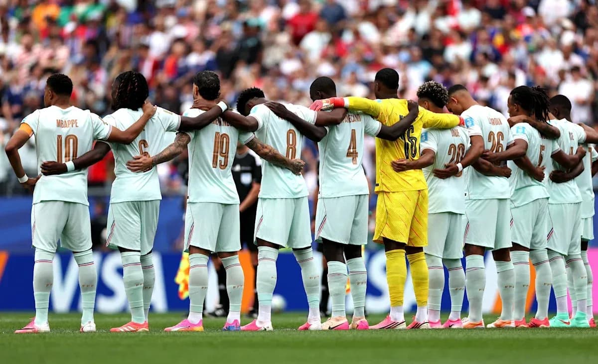 Players from France standing in solidarity before match