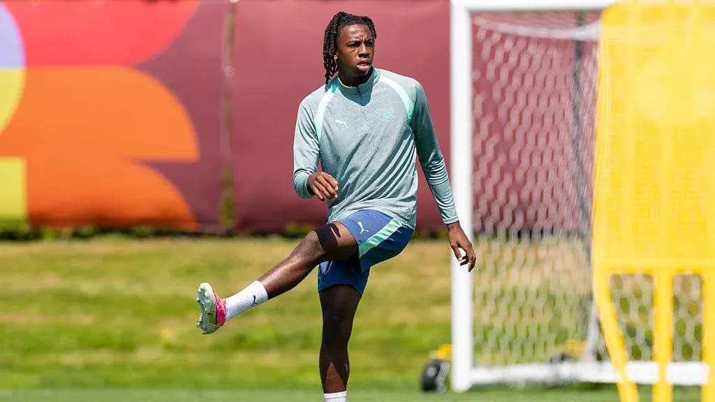 Player stretching during training session on field