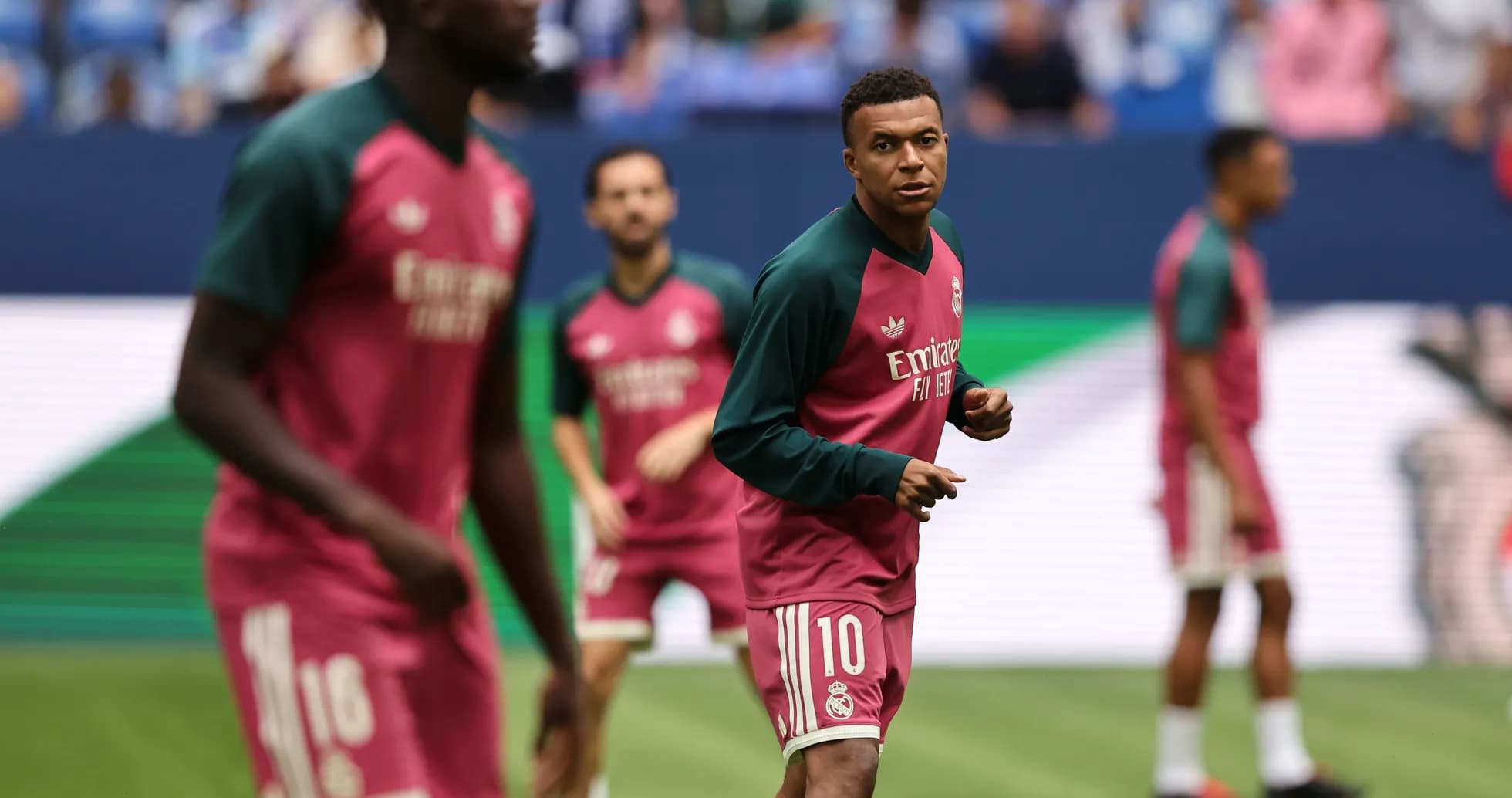 Players warming up in Real Madrid training jerseys