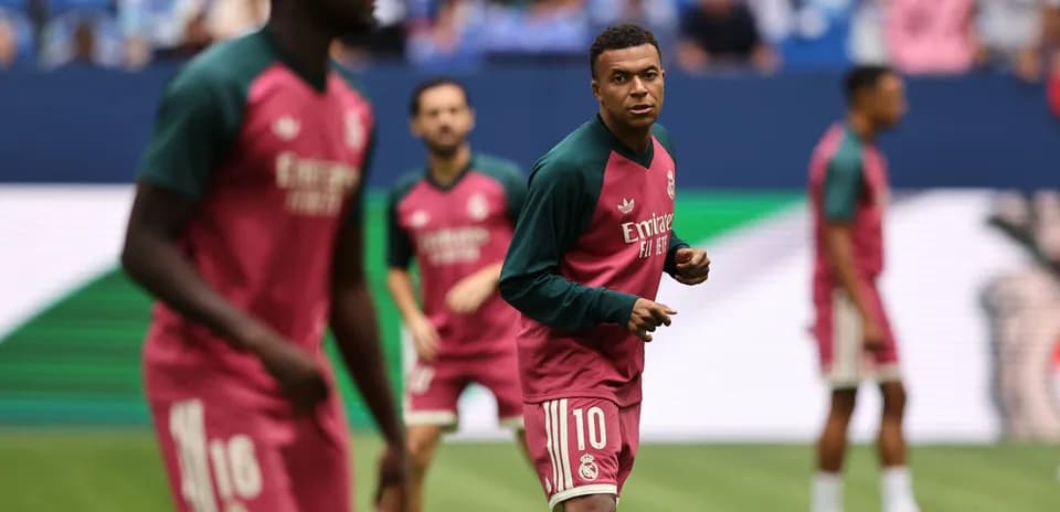 Players warming up in Real Madrid training jerseys