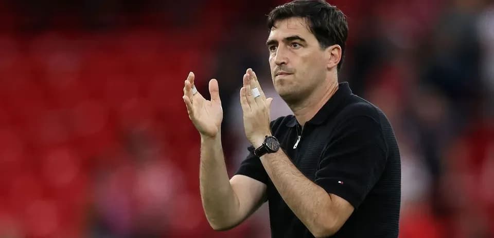 Coach applauding during a match on the sidelines