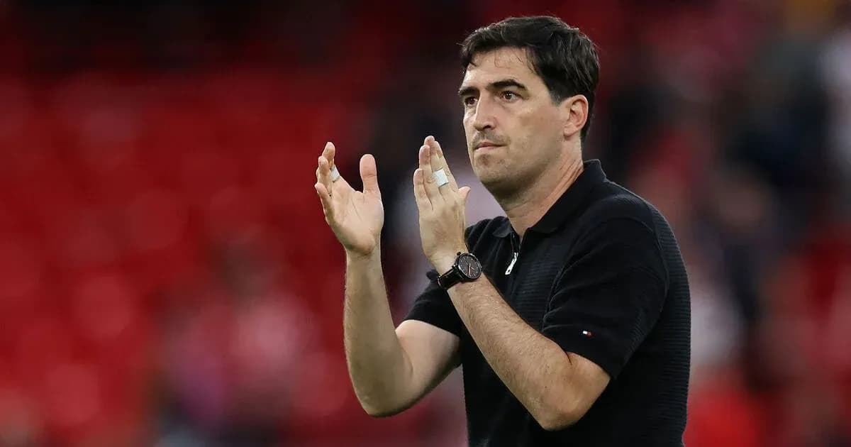Coach applauding during a match on the sidelines