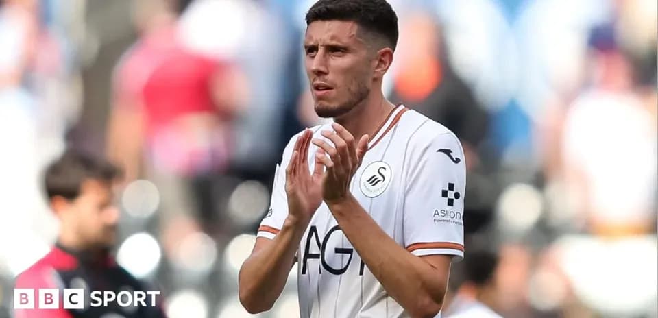 Swansea City player clapping to fans after match