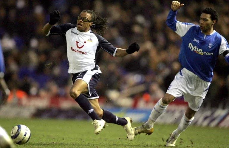Player evading a tackle during a football match