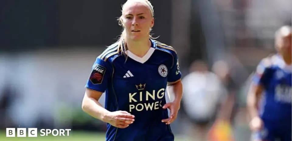 Female player in blue kit running on the field