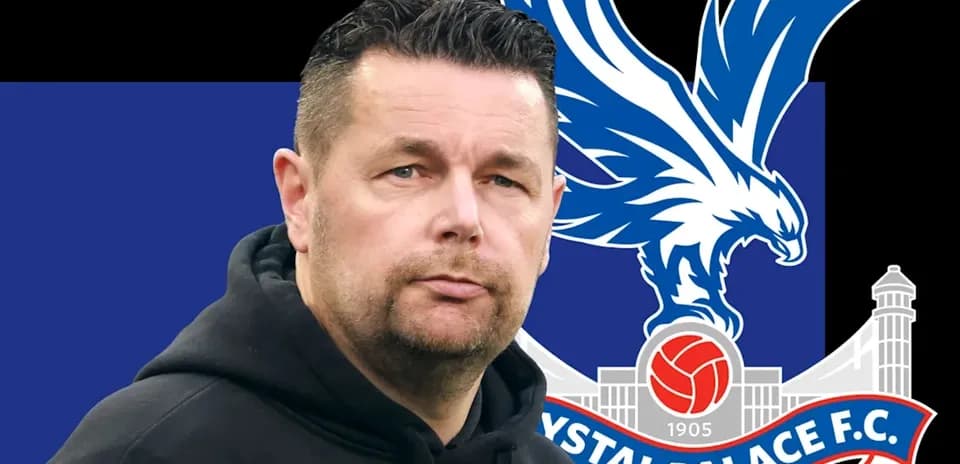 Coach in front of Crystal Palace FC logo backdrop