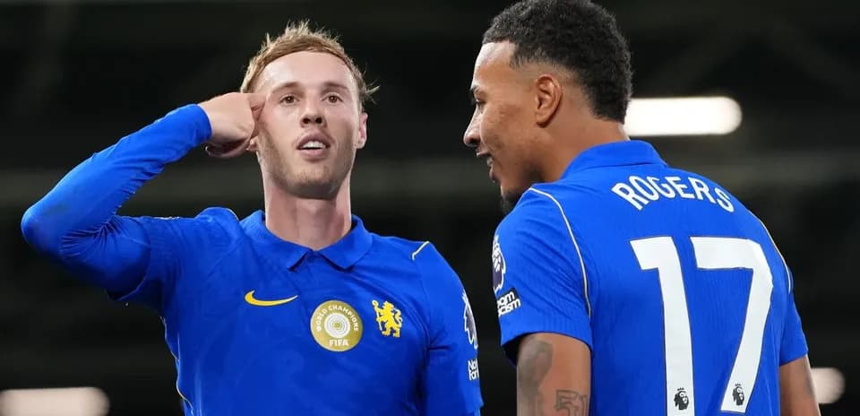 Two players celebrating after a goal on pitch