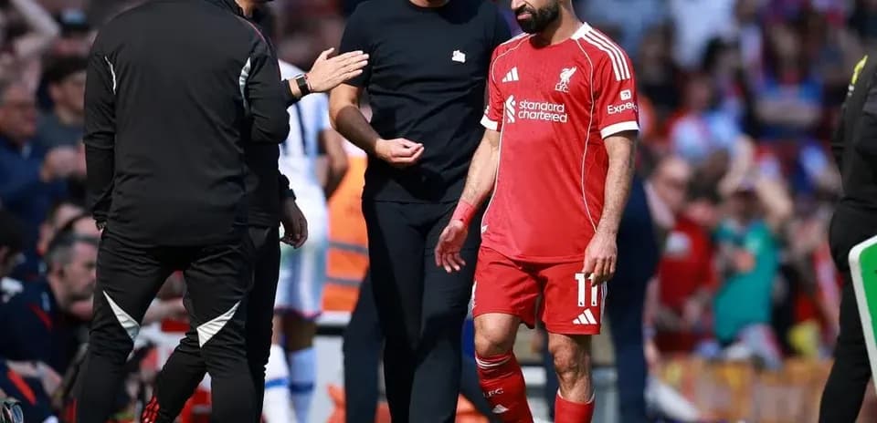 Mohamed Salah walking off field with coaches
