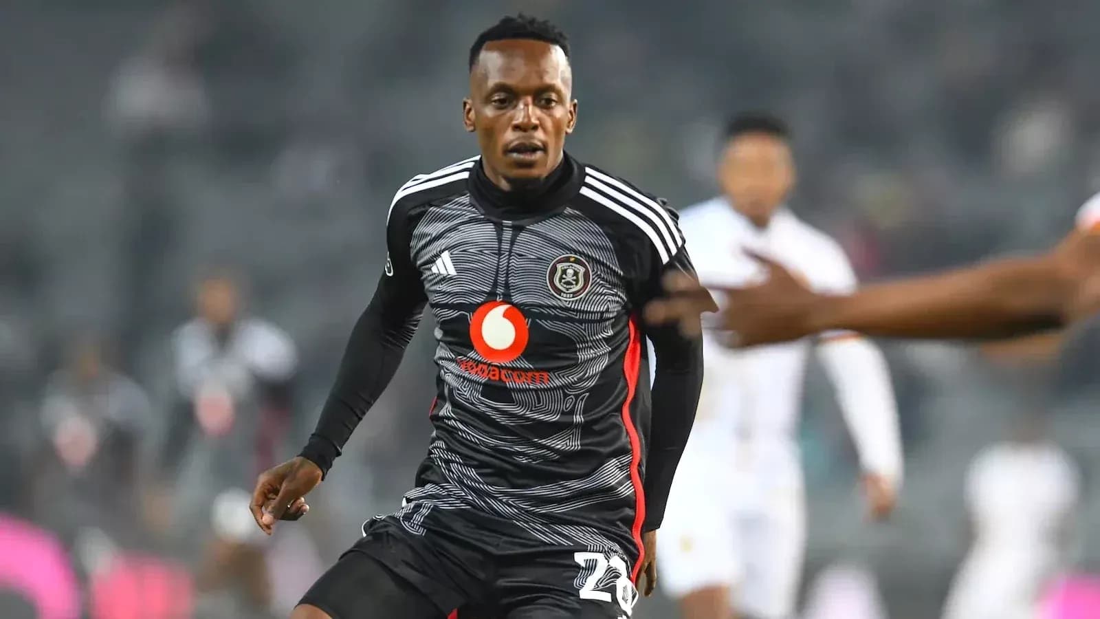 Player in black jersey running during a match