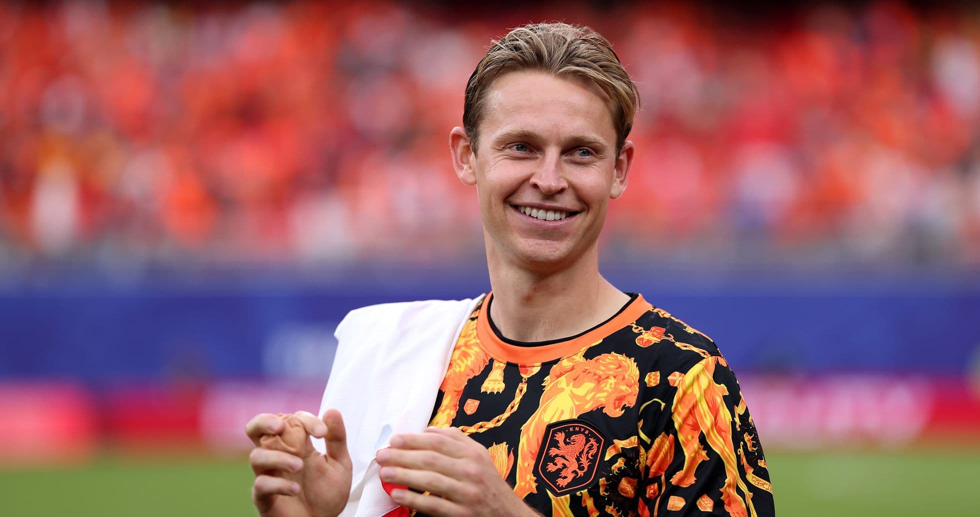 Player in vibrant shirt smiling during warm-up