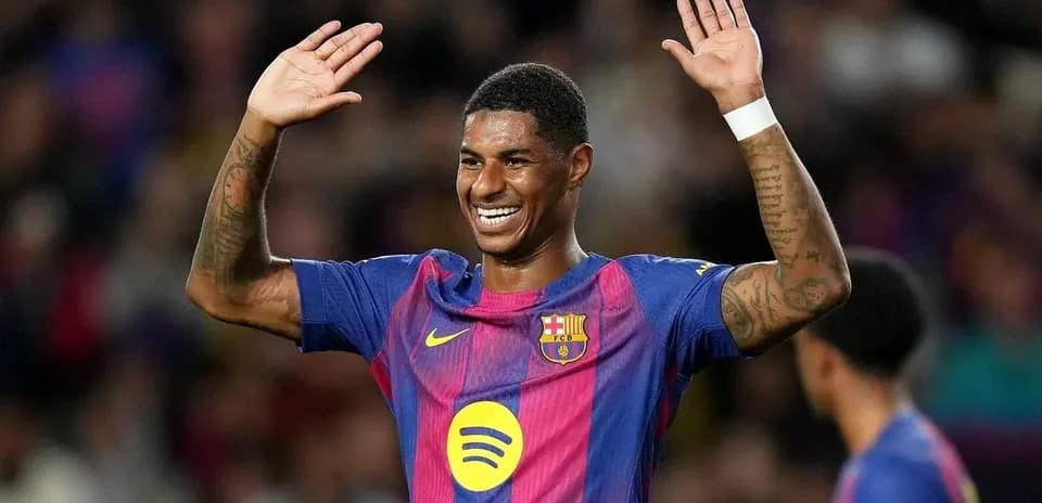 Player celebrating with arms raised in stadium