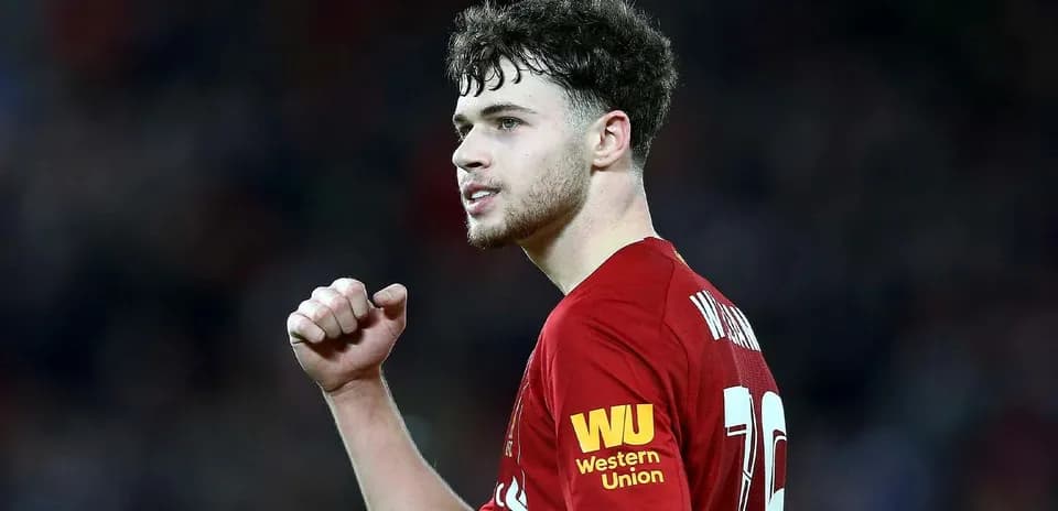 Player celebrating during a match in Liverpool kit