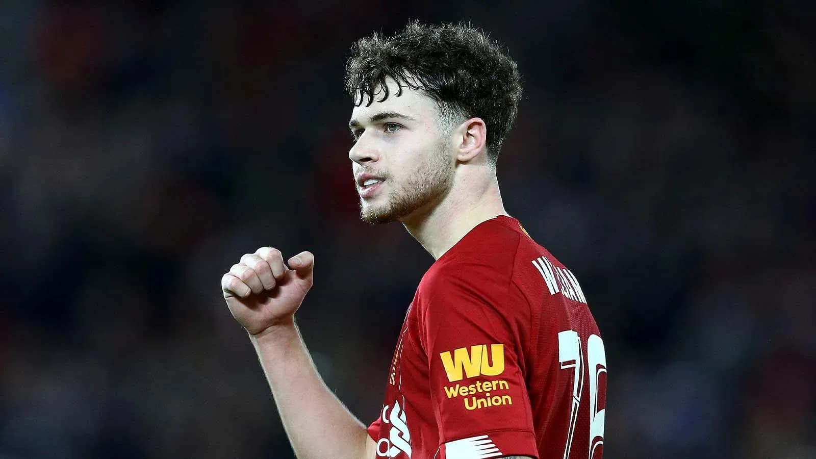 Player celebrating during a match in Liverpool kit