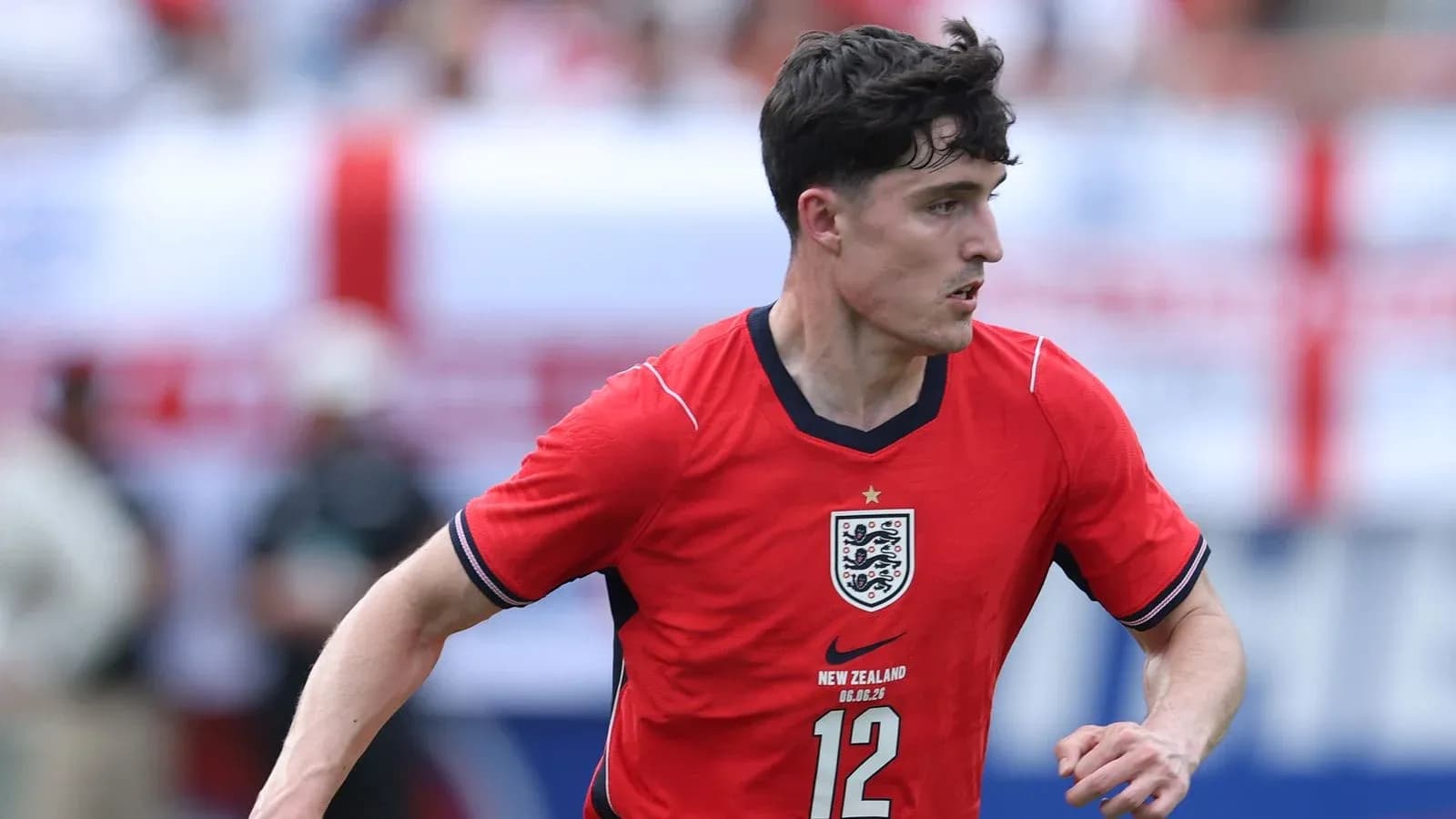 Player in red England jersey running on field