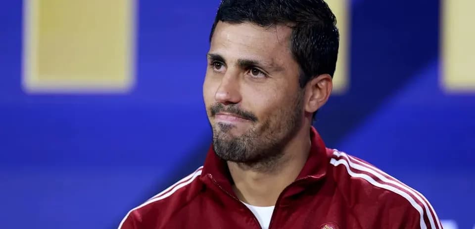 Football player at press conference wearing Spain tracksuit